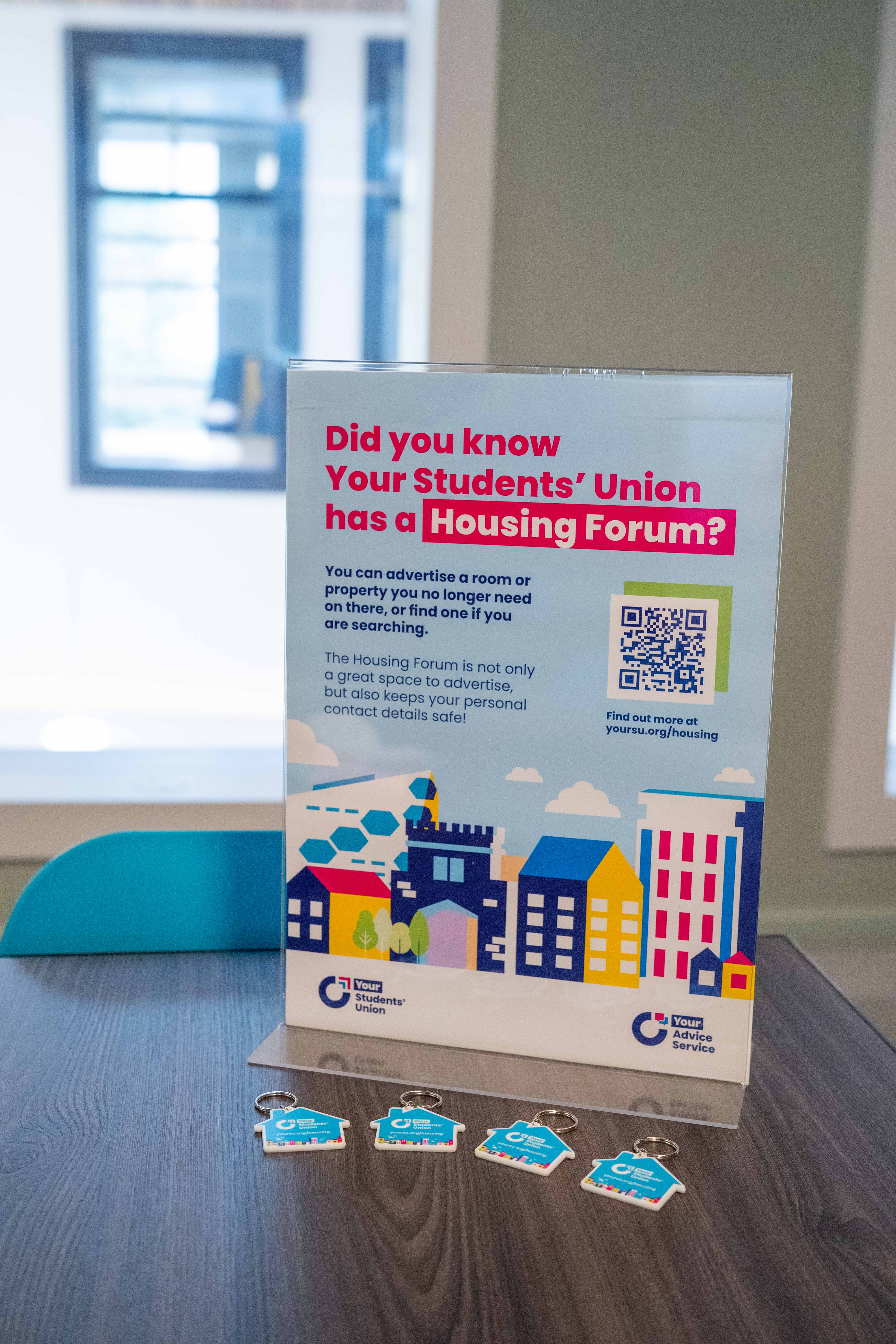 Poster about housing placed on a table.