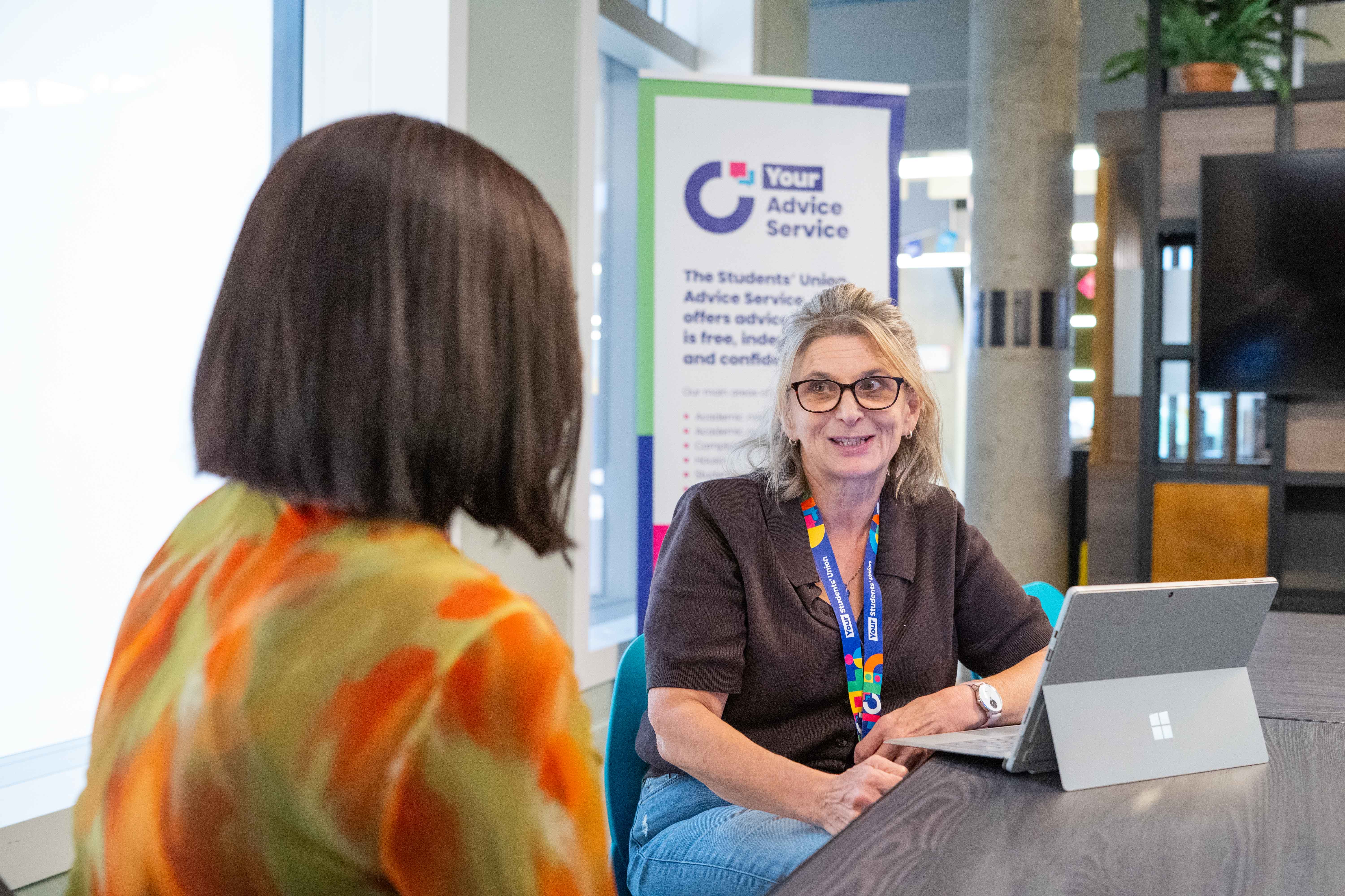 Two people sat engaging in a conversation.
