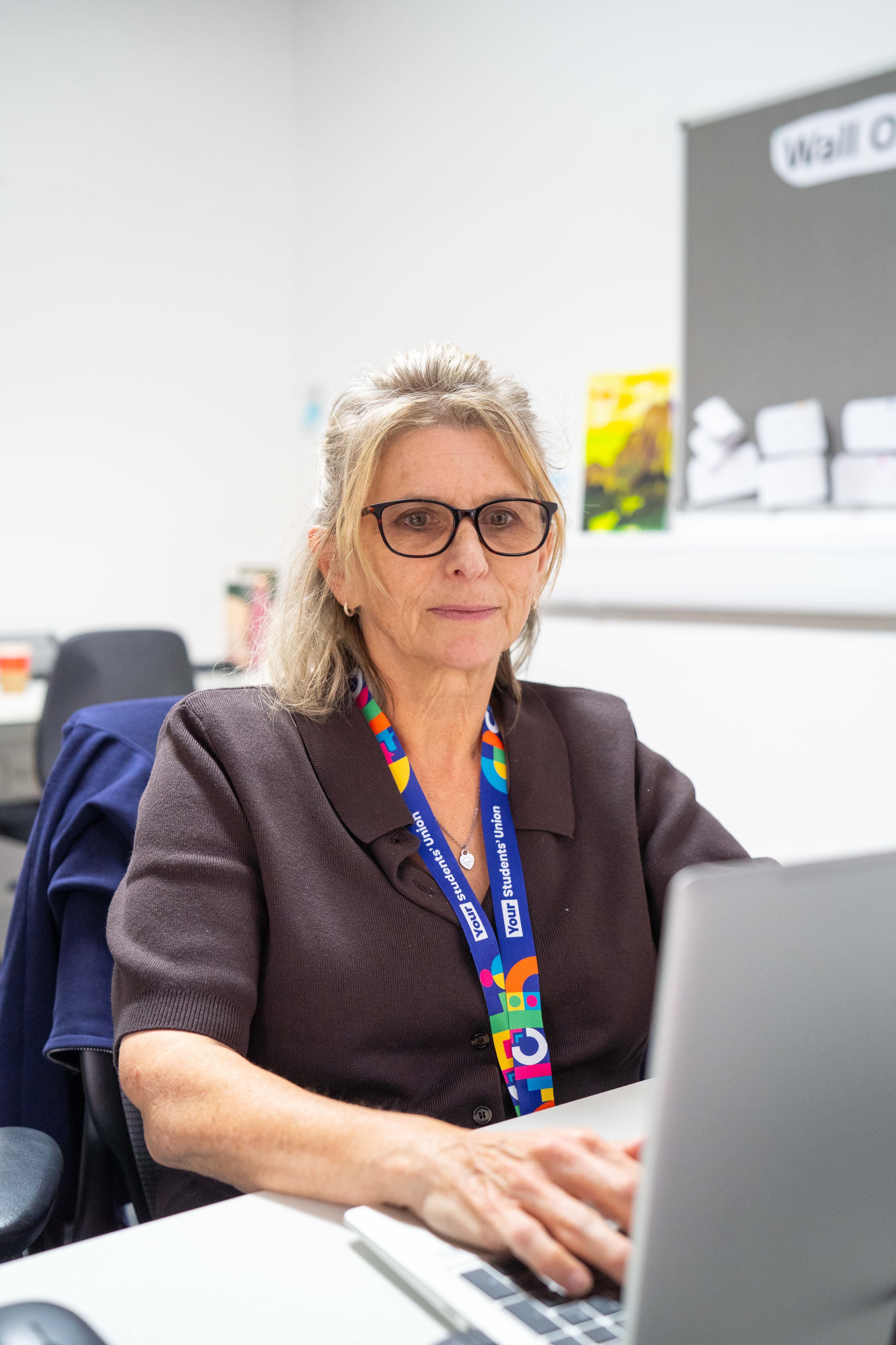 A Your Advice Service staff member looking at a laptop screen.