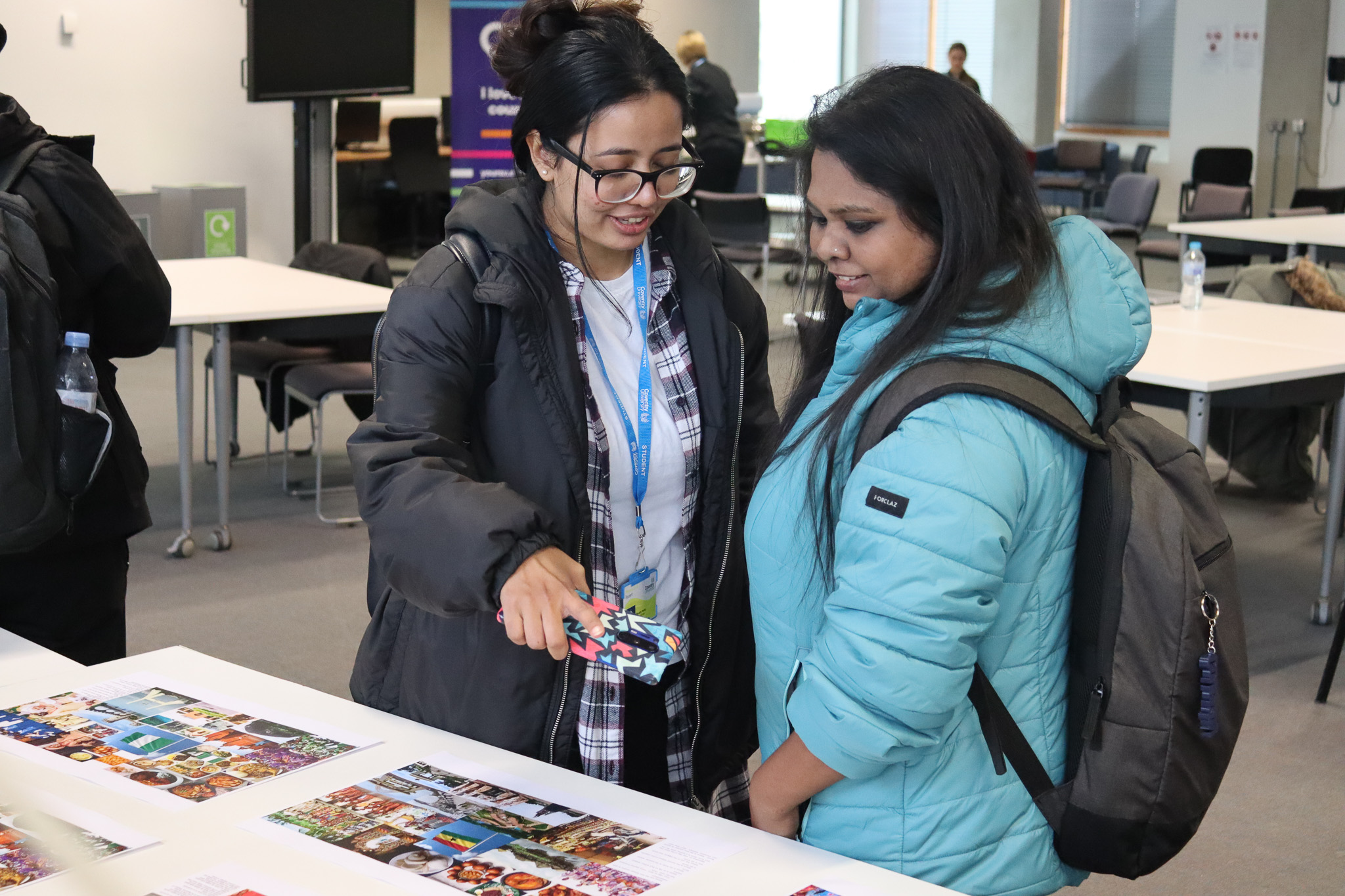 Students looking at the leaflets lying on the stall.