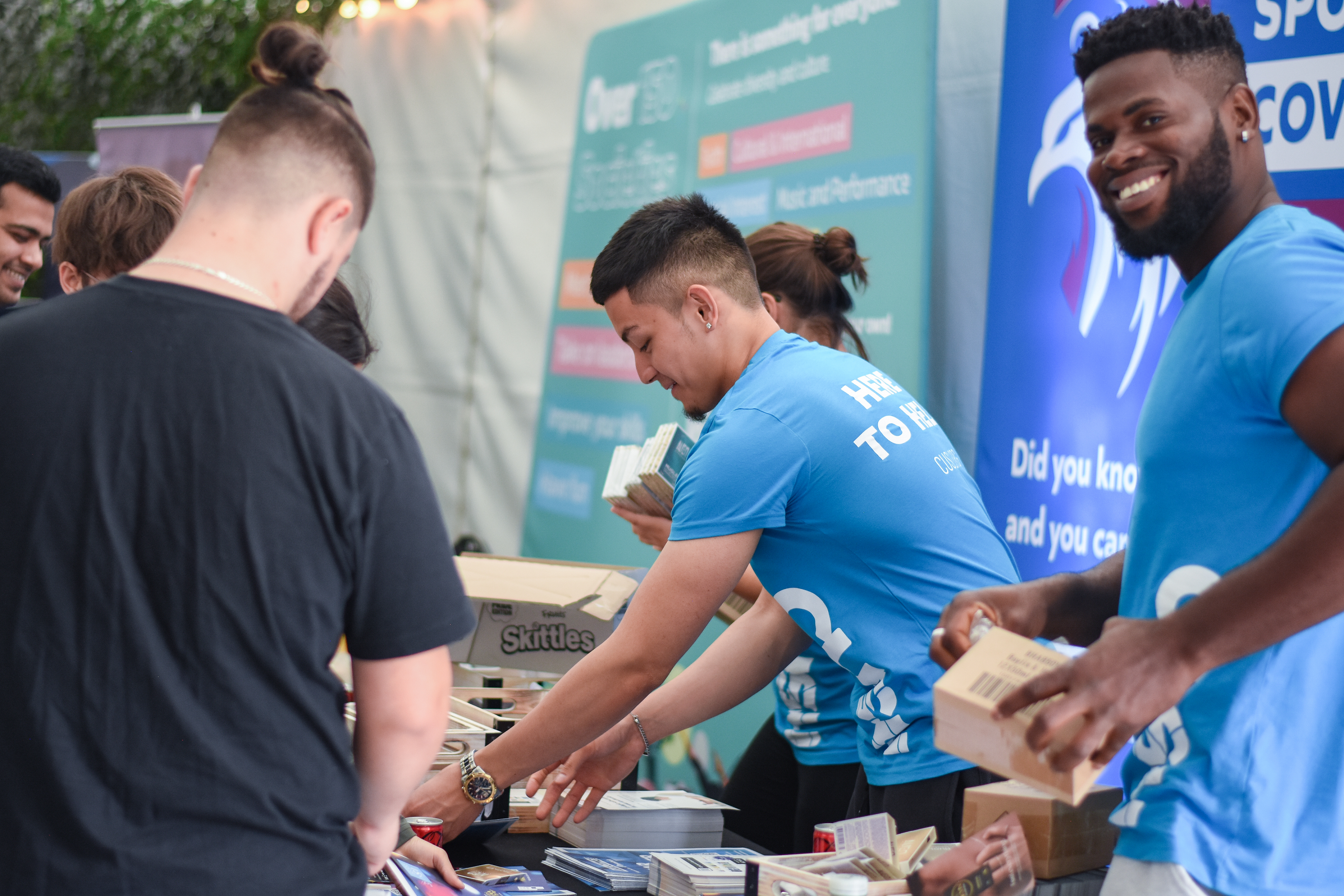 Two students stocking a table to give away free items.