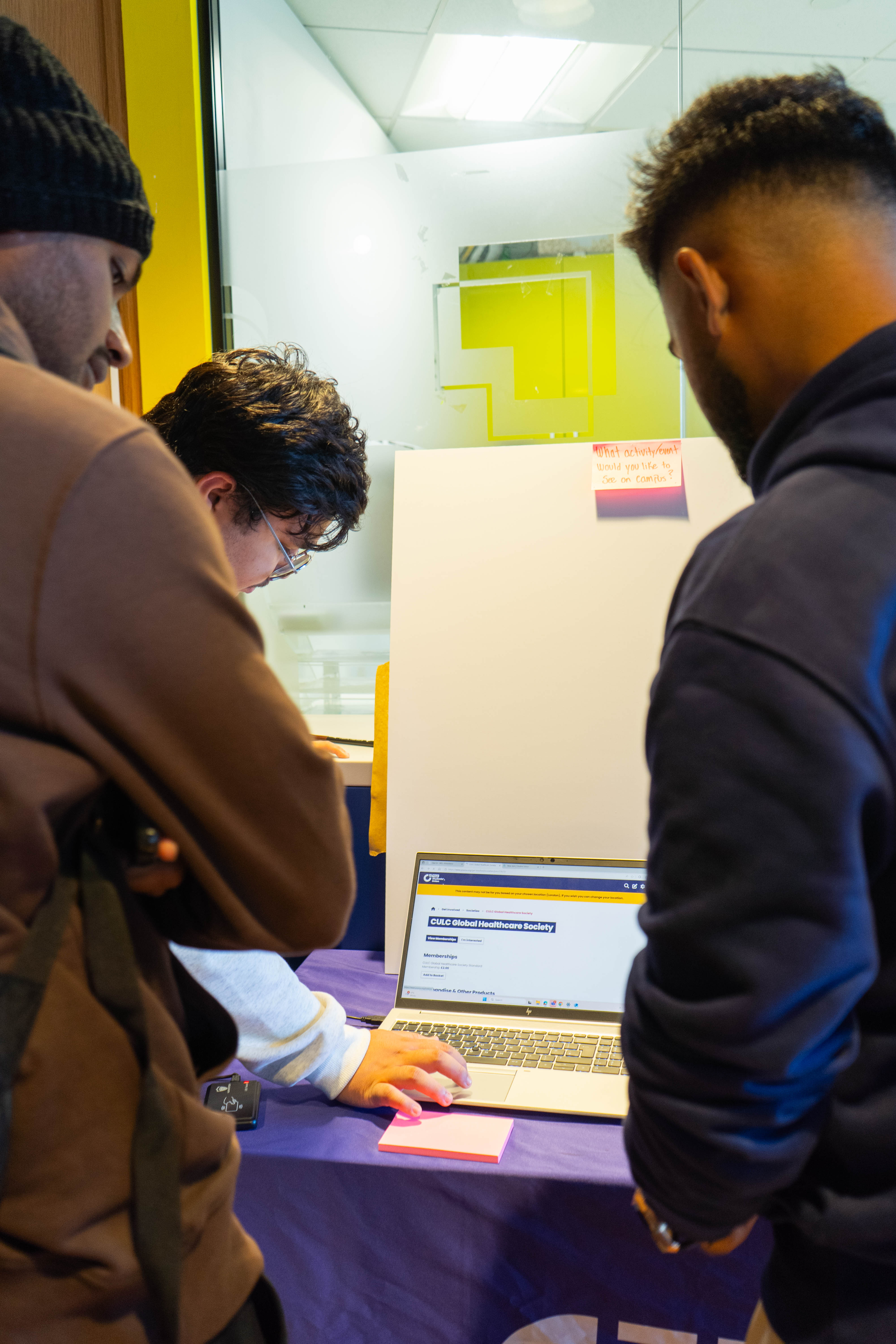 People looking at a laptop screen.