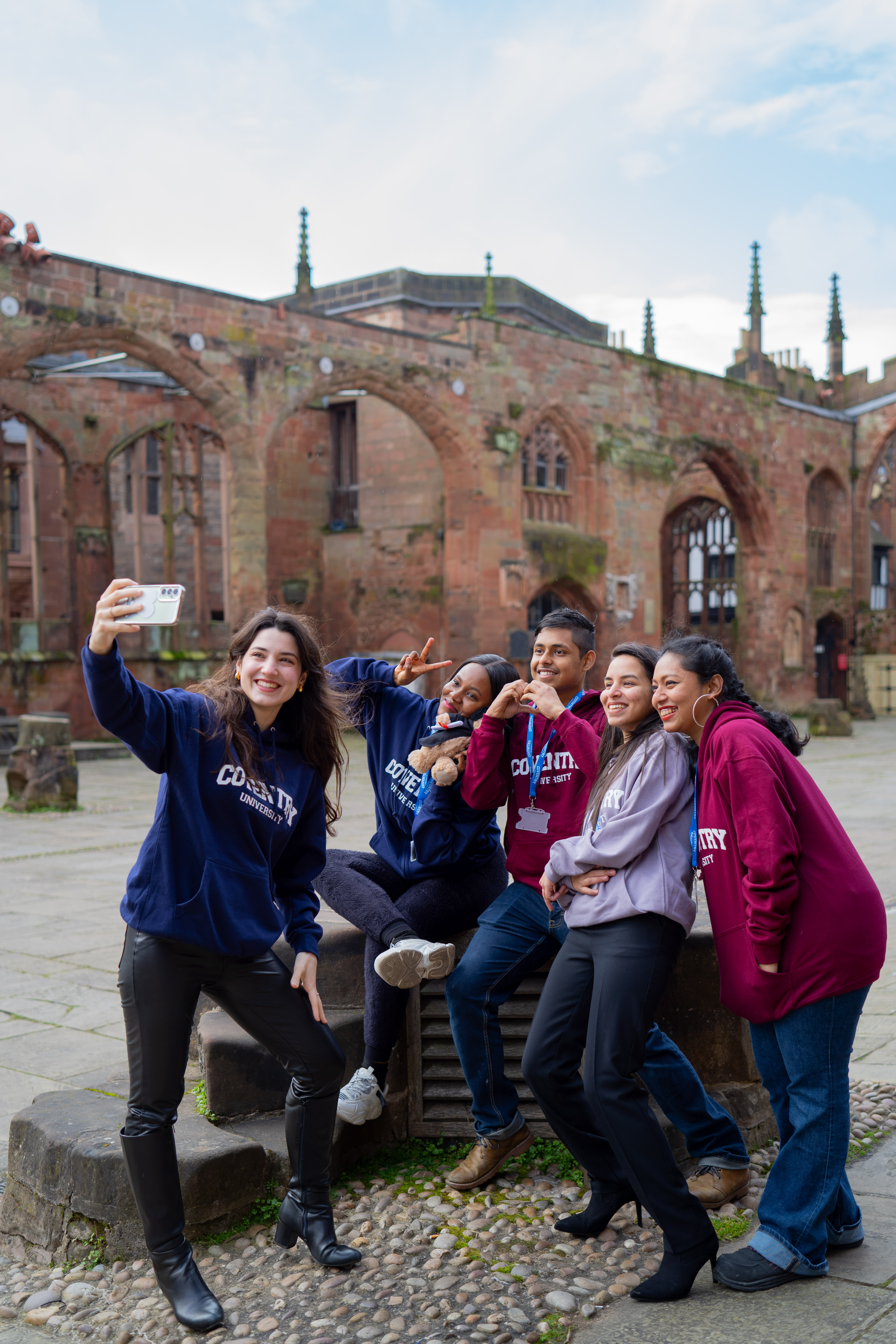 The four part time officers sitting on the wall in Coventry University Clothing