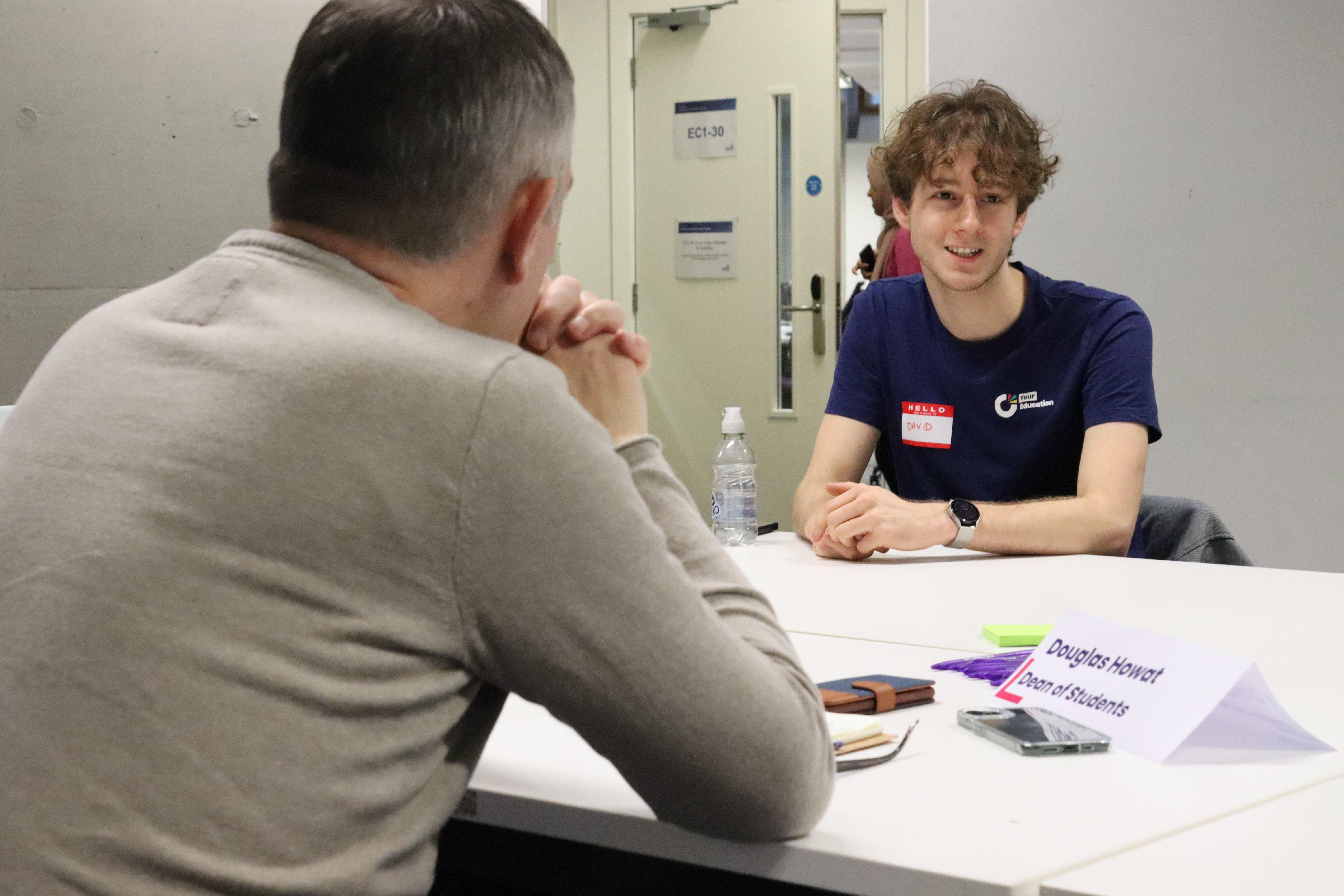 A student speaking to a member of university staff.